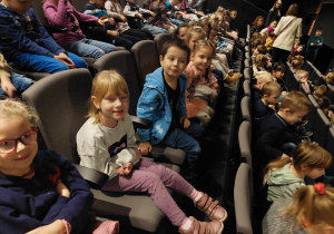 Dzieci siedzą na widowni teatru w oczekiwaniu na spektakl. .