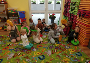 Dzieci siedzą na dywanie w "bazie".