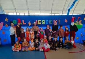 dzieci wraz z Paniami pozują do zdjęcia pod napisem "bal jesieni"